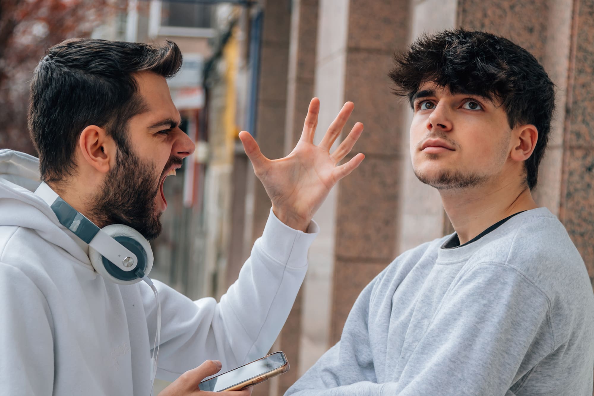 young people arguing in the street outdoors young people arguing in the street outdoors