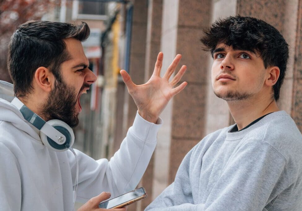 young people arguing in the street outdoors